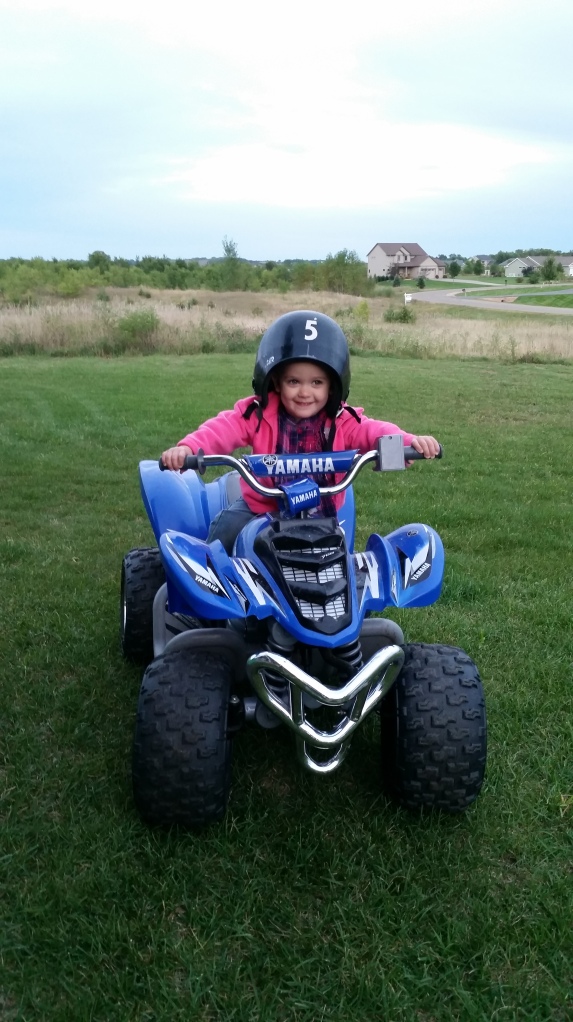 We turned away for 1 minute and she climbs on  the four wheeler